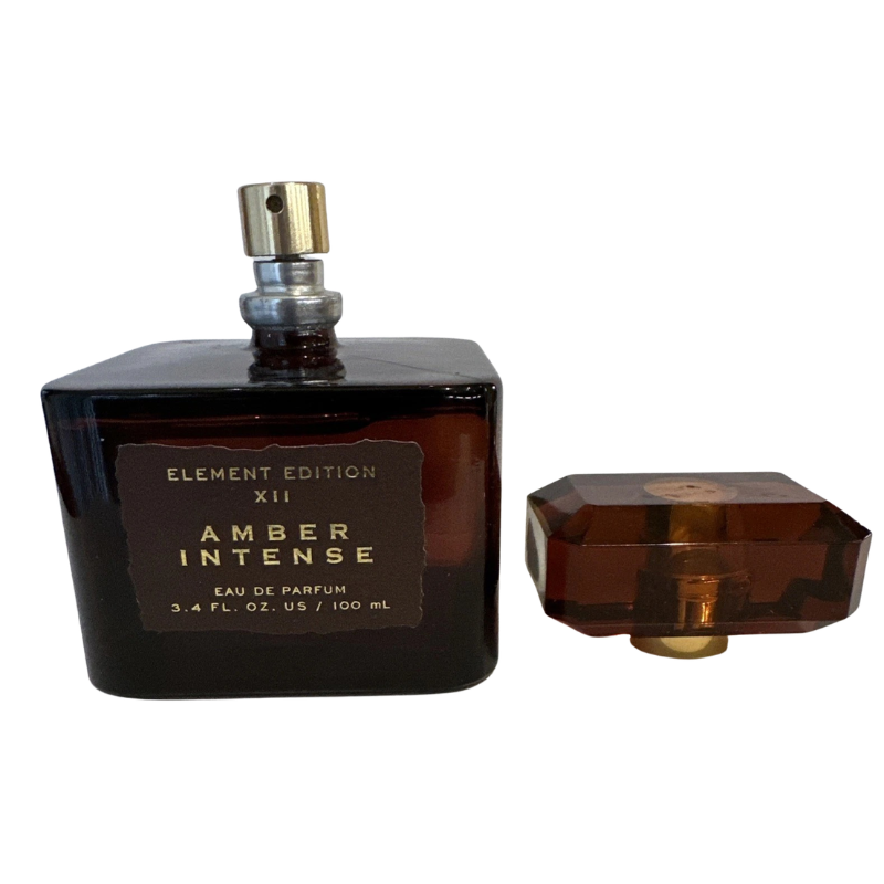 Side view of Tru Fragrance Amber Intense perfume bottle with cap removed showing the gold spray atomizer.