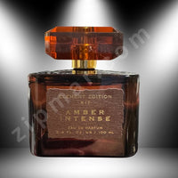 Thumbnail for Perfume bottle labeled 'Amber Intense' with a dark glass and gold cap on a gray background.