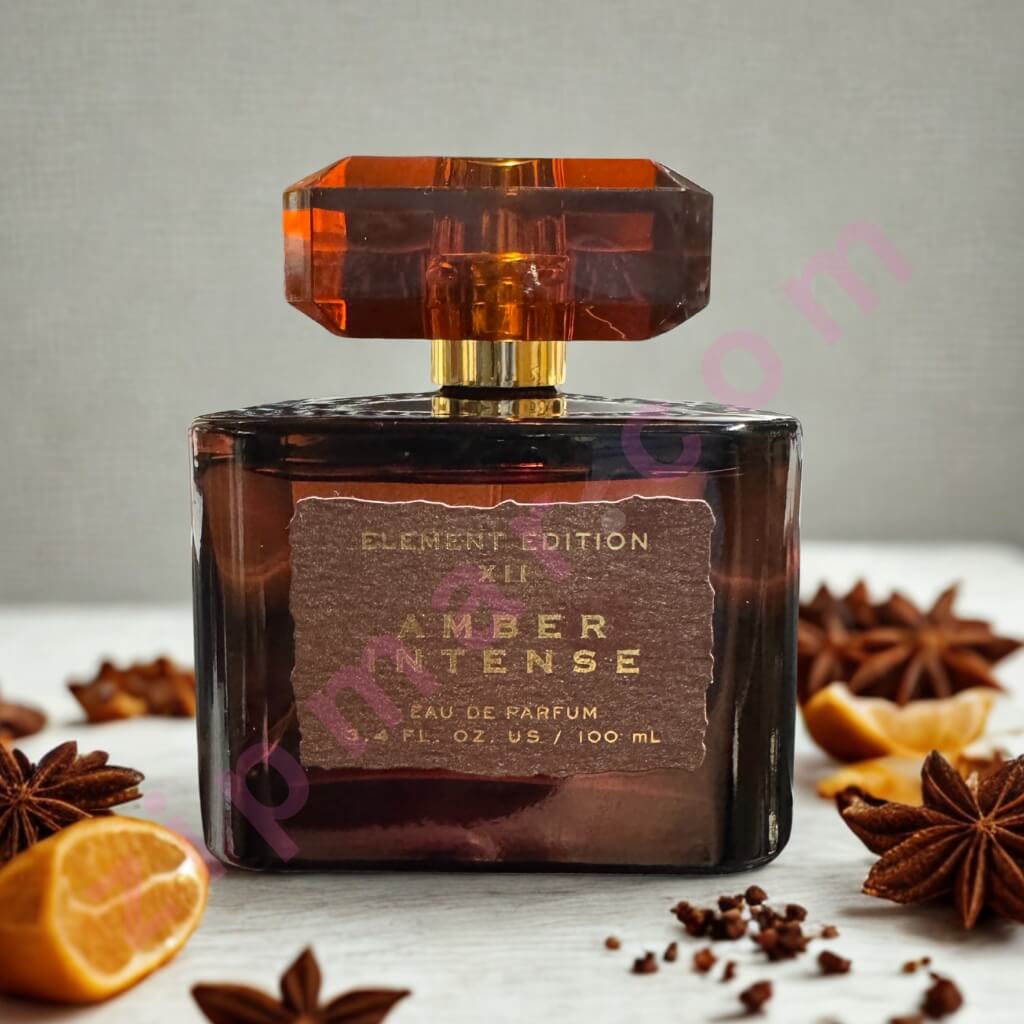 Amber Intense perfume bottle with star anise and oranges on a light background