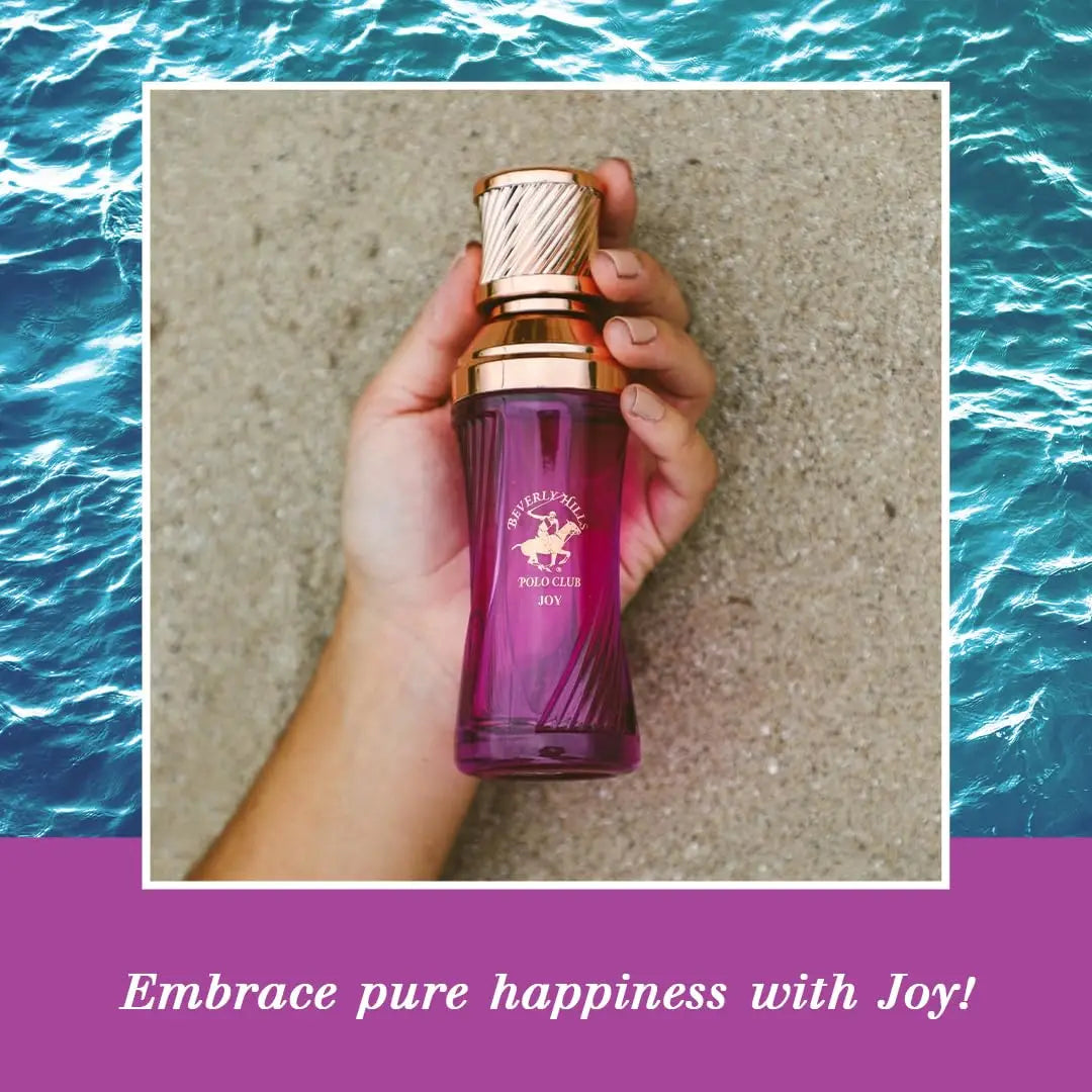 Hand holding BHPC Joy perfume bottle against a beach background to represent pure happiness.
