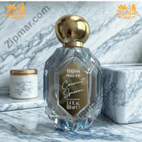 Thumbnail for Bijou Sucré Coconut Squeeze perfume bottle with gold cap on a blue marble surface