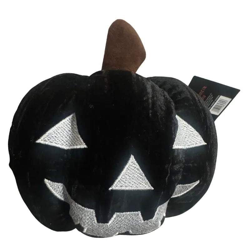Close-up of silver embroidered jack-o'-lantern face on Black Velvet Pumpkin Pillow