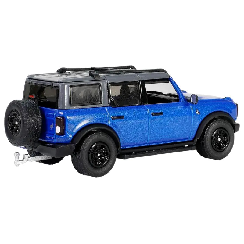 Close up of the rear of a blue Ford Bronco diecast car showing the spare tire and tow hitch.