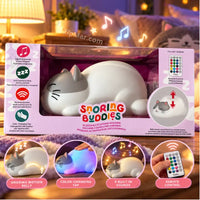 Thumbnail for Brilliant Innovations Snoring Buddies sleeping cat sound machine in bedroom setting showing snoring motion belly, color-changing tap, 9 built-in sounds, and remote control