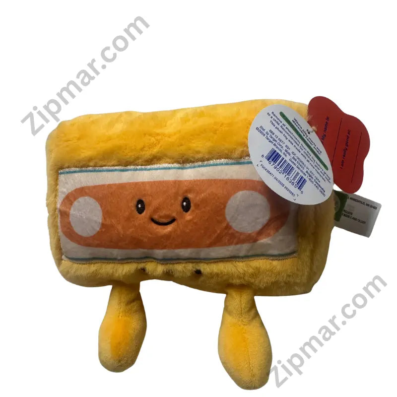 Yellow cassette tape plush front view with smiley face label and hang tags”