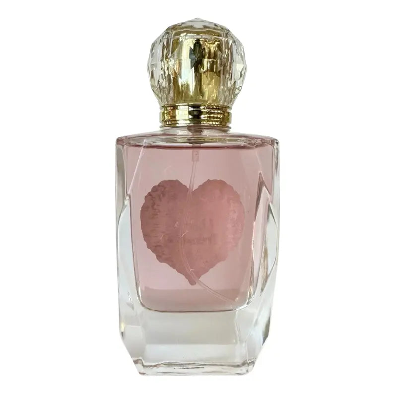 Rear view of the clear faceted glass bottle for Cherry Treasure showing the pink-tinted fragrance liquid.