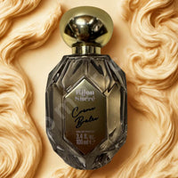 Thumbnail for Perfume bottle with gold cap on a textured beige background