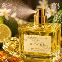 Thumbnail for Element Edition X Citrine Eau de Parfum bottle with gold sprayer spraying a fine mist and cap beside it