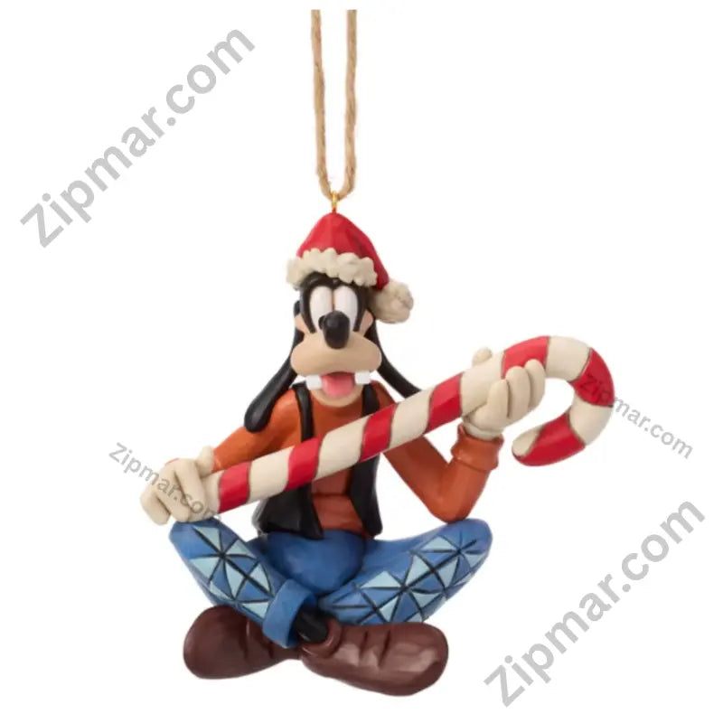 Enesco Jim Shore Goofy holiday ornament — Goofy seated cross-legged in Santa hat, orange sweater, blue diamond-patterned pants, holding candy cane
