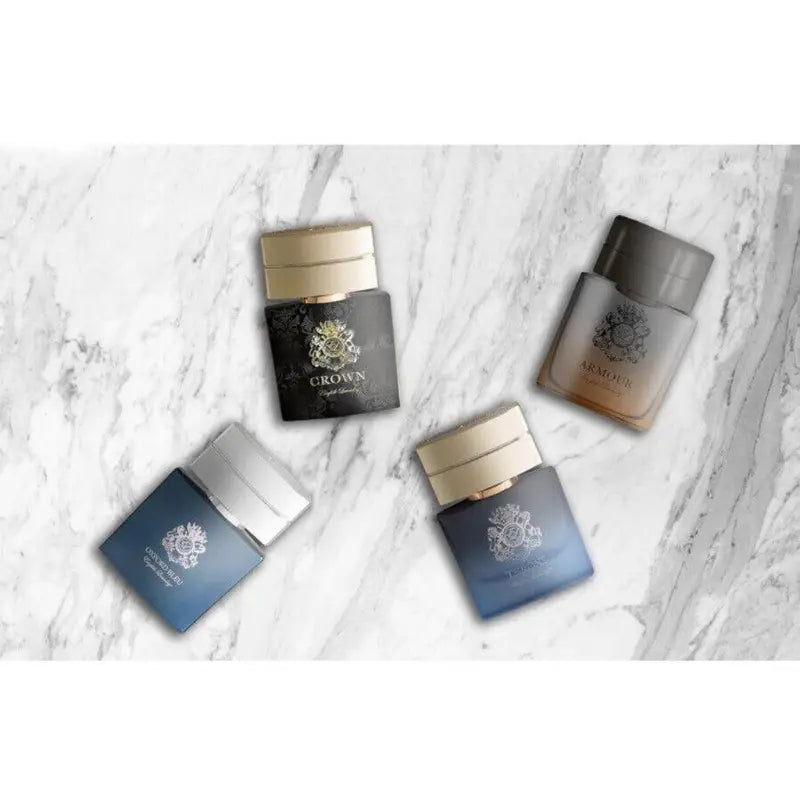Four English Laundry mini fragrance bottles arranged artistically on a white marble surface.