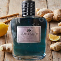 Thumbnail for Blue cologne bottle labeled 'Four of a Kind' on a wooden surface with lemons and ginger.