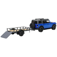 Thumbnail for Rear view of 1:64 scale Ford Bronco towing a utility trailer with a lowered loading ramp.