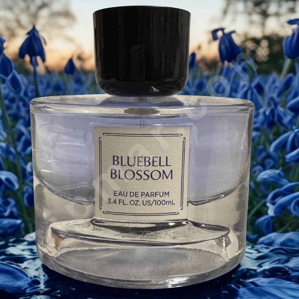 Clear perfume bottle labeled 'Bluebell Blossom' with a black cap, set against a background of bluebell flowers.