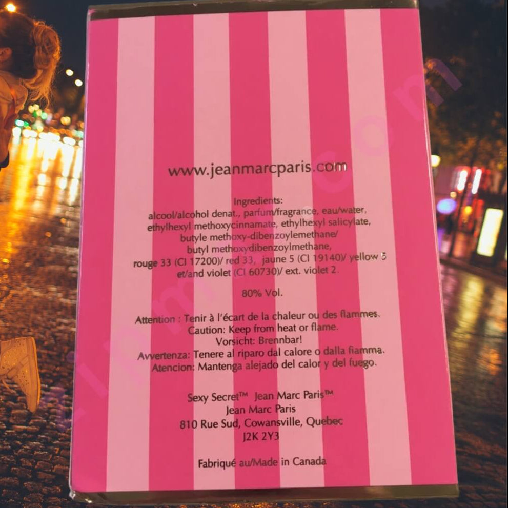 Pink and white striped product packaging with text on a blurred outdoor background