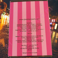 Thumbnail for Pink and white striped product packaging with text on a blurred outdoor background