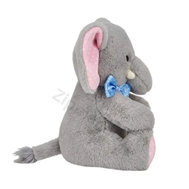 Gray elephant plush toy side view with a pink polka dot ear, blue bow, white tusk and tufted tail