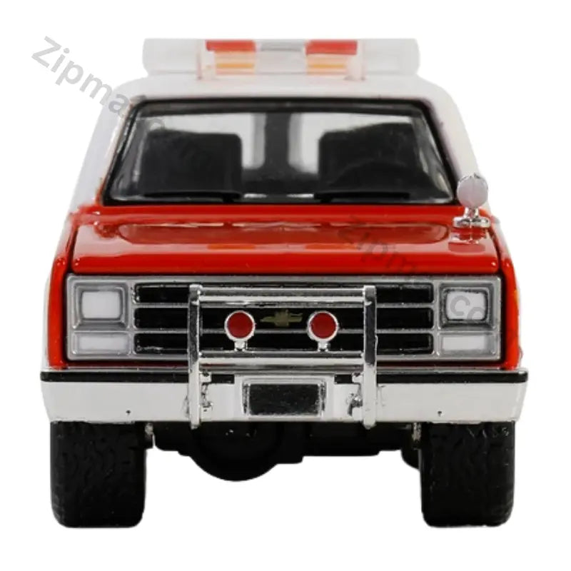 Front view of Greenlight 1991 Chevrolet Suburban FDNY diecast car with chrome push bar and roof light bar