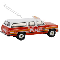 Thumbnail for Red and white 1991 Chevrolet Suburban FDNY Battalion Chief 1:64 diecast car rear three quarter view with FIRE graphics