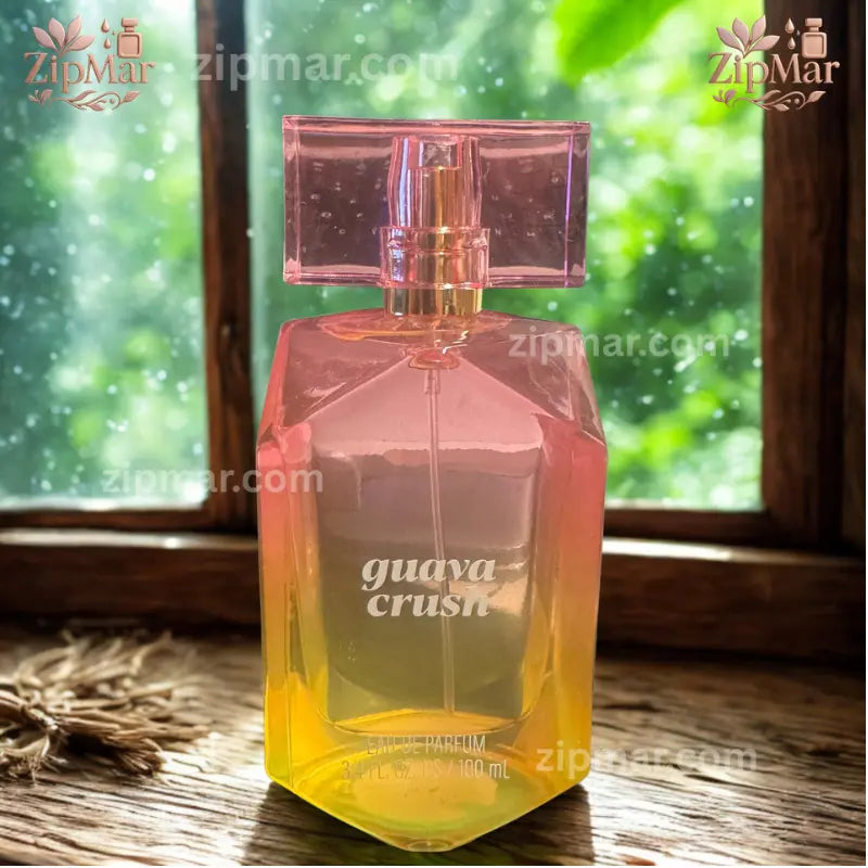 Guava Crush Eau De Parfum 3.4 fl oz pink-yellow gradient glass bottle on wooden window sill