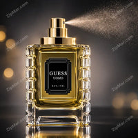 Thumbnail for Guess Uomo Est 1981 faceted glass bottle with black label and gold collar and spray pump on a dark background