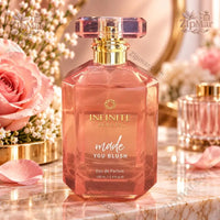Thumbnail for Infinite Beauty Made You Blush Eau de Parfum 3.4 fl oz rose-pink faceted bottle front view with floral display