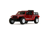 Thumbnail for Side profile of the Jada Pink Slips Jeep Gladiator showing the white custom graphics and Rubicon decals.
