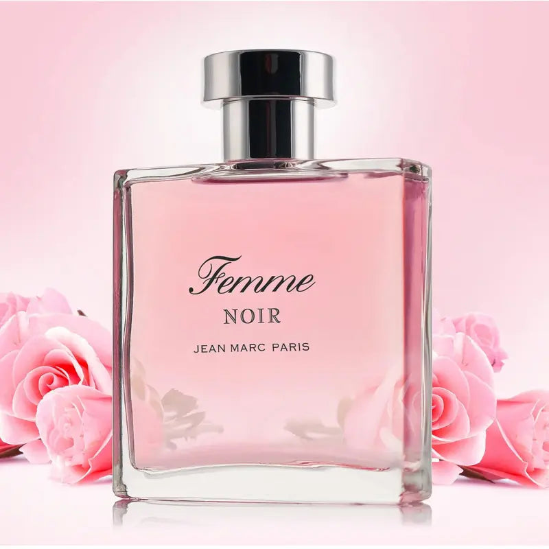 Jean Marc Paris Femme Noir Eau de Parfum 3.4 oz bottle surrounded by pink roses, showcasing the floral and romantic scent profile.