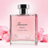Thumbnail for Jean Marc Paris Femme Noir Eau de Parfum 3.4 oz bottle surrounded by pink roses, showcasing the floral and romantic scent profile.