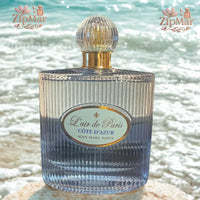 Thumbnail for Front view of Jean Marc Paris L'air de Paris Cote d'Azur EDP bottle resting on shoreline with sparkling ocean waves background