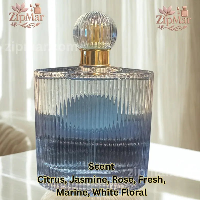 Rear perspective view of fluted glass bottle listing scent notes including citrus, jasmine, rose, marine, and white floral