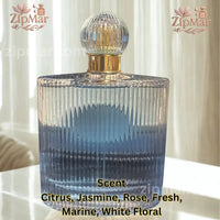 Thumbnail for Rear perspective view of fluted glass bottle listing scent notes including citrus, jasmine, rose, marine, and white floral