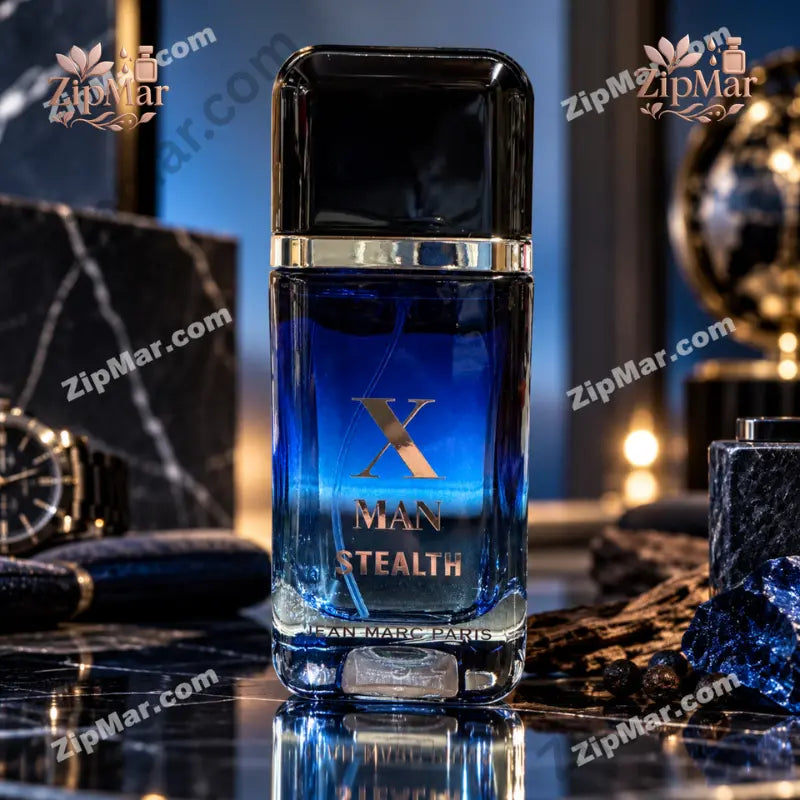 Jean Marc Paris X Man Stealth Eau de Toilette midnight blue gradient bottle with black cap and gold collar band on dark marble surface luxury editorial with chronograph watch fountain pen blue mineral stone and gold geometric globe ornament with warm bokeh background