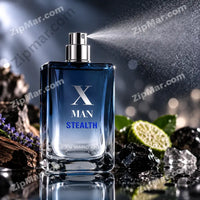 Thumbnail for Jean Marc Paris X Man Stealth EDT 100ml in active mid-spray with silver chrome pump and X Man Stealth label clearly visible dark driftwood bark lavender sprigs ice crystals and halved citrus bergamot arranged around bottle on reflective dark surface with blue bokeh background