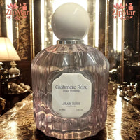 Thumbnail for Jean Rish Cashmere Rose Pour Femme Eau de Parfum 3.4 fl oz fluted pink glass bottle with cream cap on a marble counter