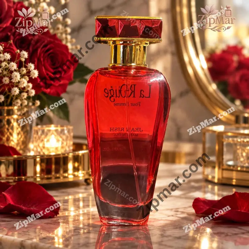 Jean Rish La Rouge Pour Femme red glass perfume bottle with gold collar and faceted red cap beside red roses