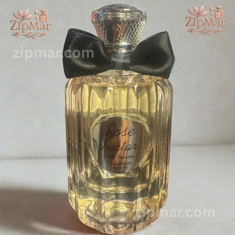 Front view of Jean Rish Rose Nectar Pour Femme Eau de Parfum bottle with silver medallion and black bow tie