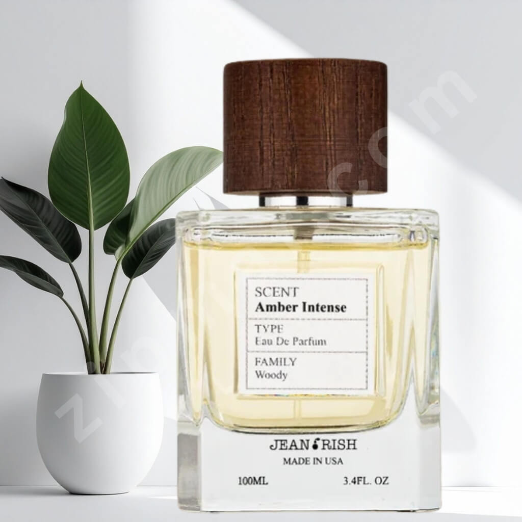 Perfume bottle labeled 'Amber Intense' by Jeanrish with a plant in the background