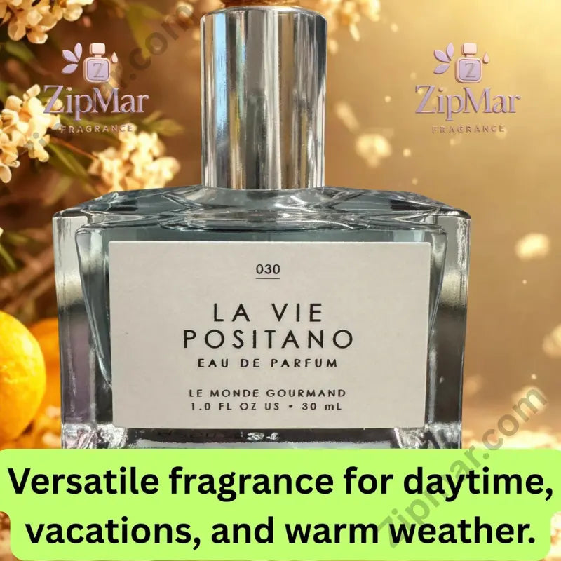 La Vie Positano Eau de Parfum styled on blue Mediterranean tile with orange slices and white blooms inspired by Positano, Amalfi Coast