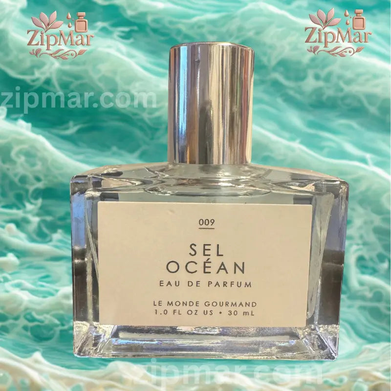 Front view of Le Monde Gourmand 009 Sel Ocean EDP bottle surrounded by lemon, white florals, and lavender