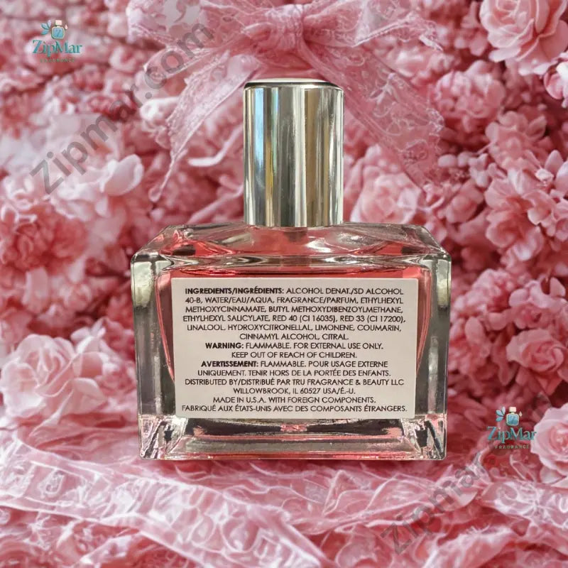Le Monde Gourmand Le Bubble Pop Eau de Parfum 30ml bottle with vibrant pink liquid silver chrome cap and white label on marble surface — gourmand lifestyle editorial with fresh strawberries pink macarons pink peony blooms white florals and crystal glass props in warm natural window light