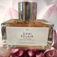 Thumbnail for Perfume bottle labeled 'Chai Eclair' with a pink floral background