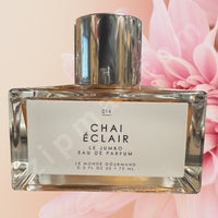Thumbnail for Perfume bottle labeled 'Chai Eclair' with a pink floral background