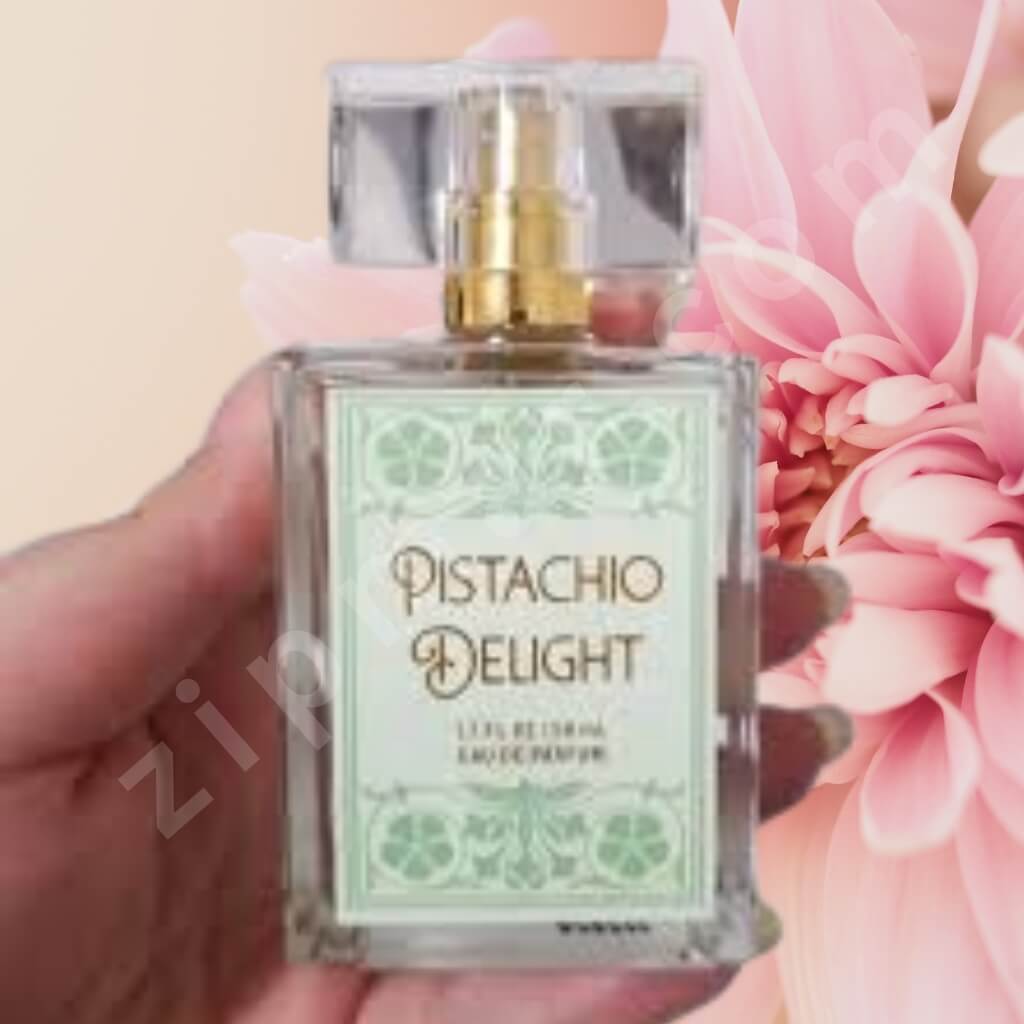 Perfume bottle labeled 'Pistachio Delight' held in front of a pink flower.