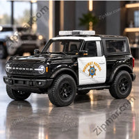 Thumbnail for Black and white Maisto Ford Bronco Highway Patrol diecast model, front three quarter view with light bar
