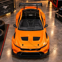 Thumbnail for Orange Maisto Ford Mustang GTD diecast model, top front view with rear wing and hood vents