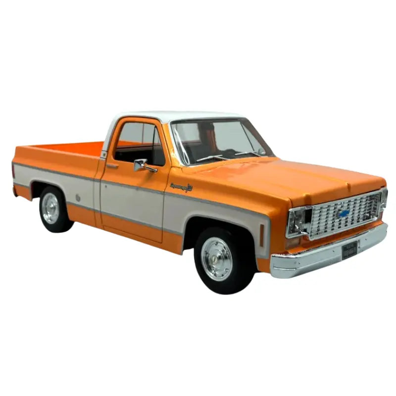 Maisto 1:18 1974 Chevrolet C10 Cheyenne Super orange and white diecast pickup truck front three-quarter view