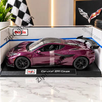Thumbnail for Maisto Corvette ZR1 Coupe diecast model car in purple with black wheels and rear wing on a display base inside its open window box
