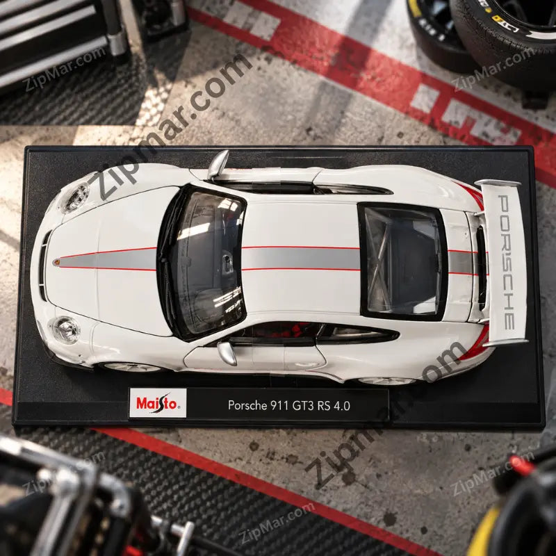 Top view of white Maisto Porsche 911 GT3 RS 4.0 1:18 diecast with red and silver stripes on display base