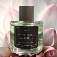 Thumbnail for Imperial Woods cologne bottle with pink flowers in the background