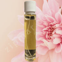 Thumbnail for Small bottle of oil with a pink flower in the background